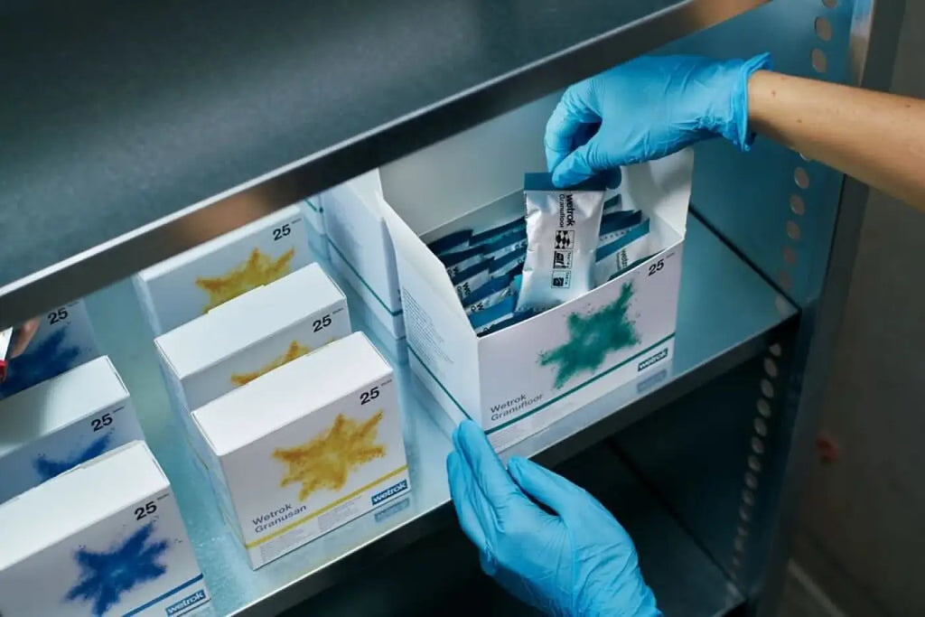 A blue and white packaged wetrok granusurf oberflächenreiniger sticks with a green starburst design on the box